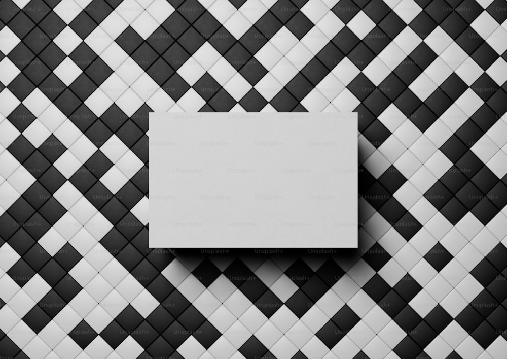 a black and white tiled wall with a white square