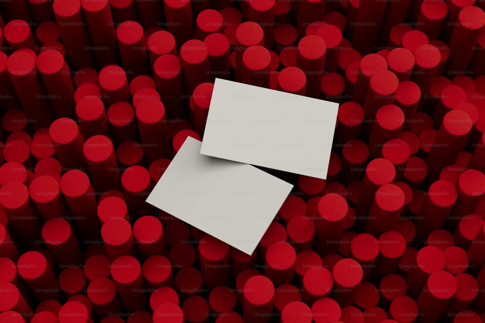 two pieces of paper sitting on top of a pile of red circles