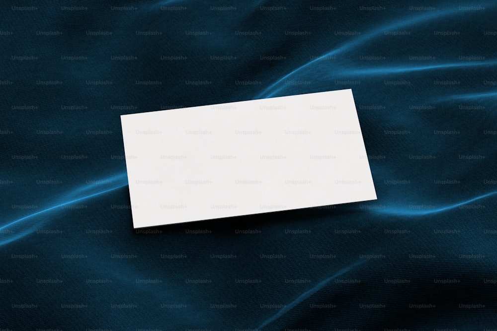 a piece of paper sitting on top of a blue cloth