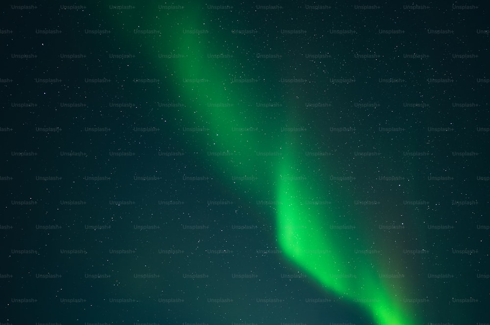 a bright green aurora bore is in the sky