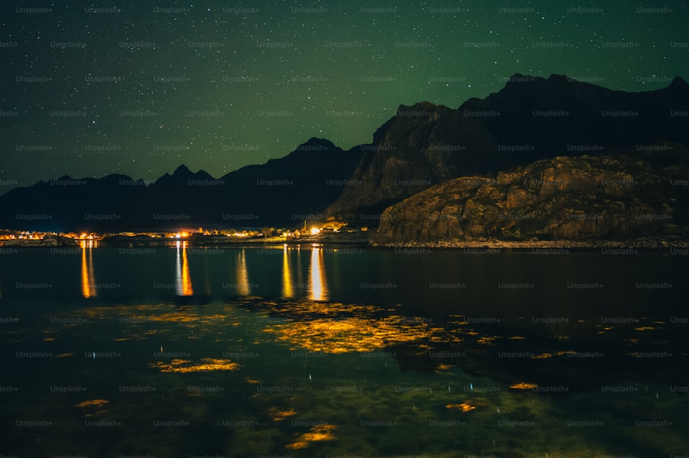 a body of water with mountains in the background