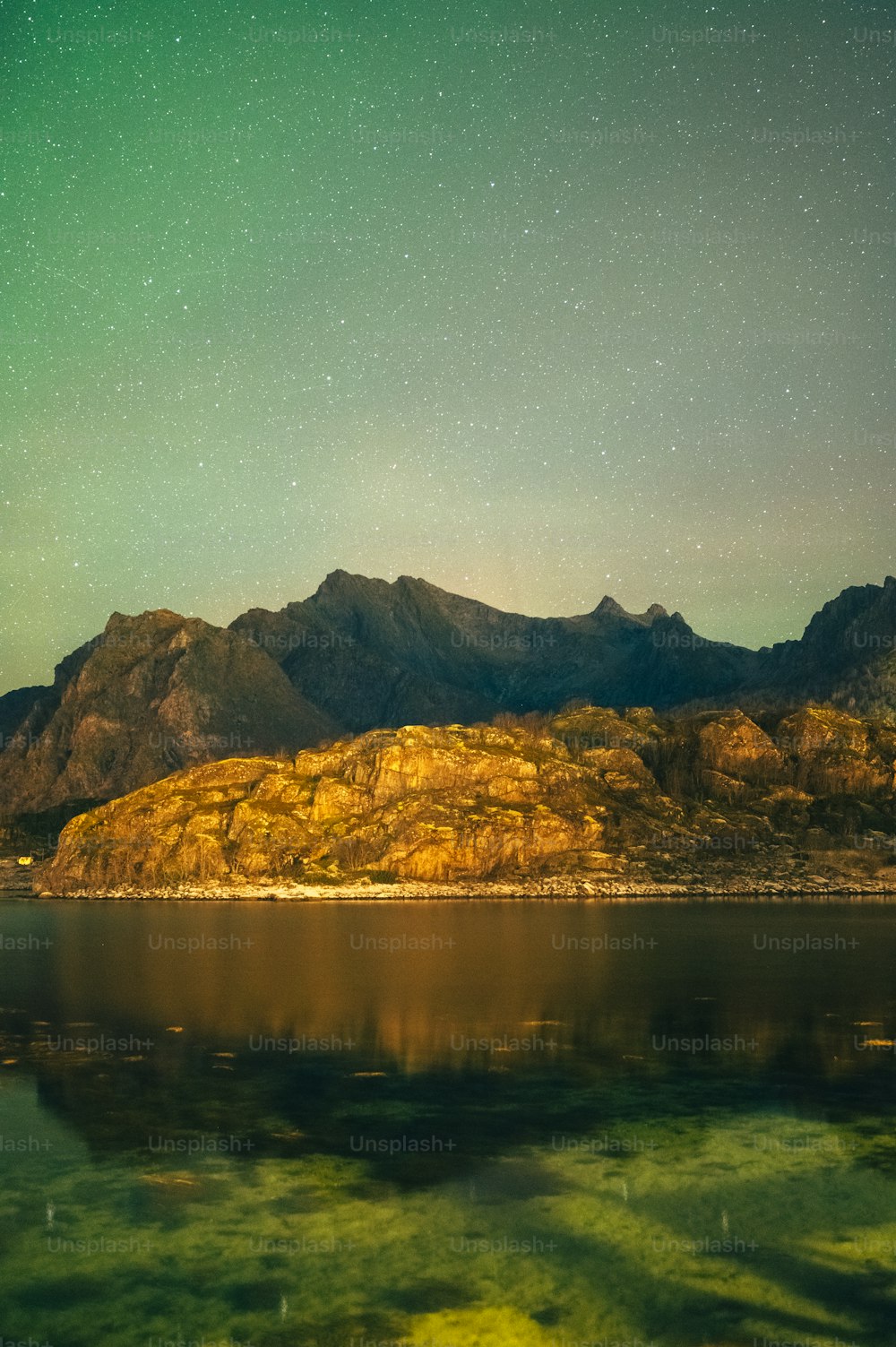 a large body of water with mountains in the background