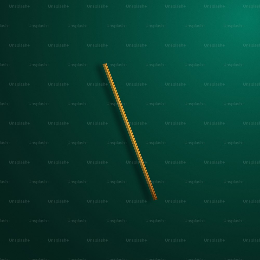 a wooden stick laying on a green surface