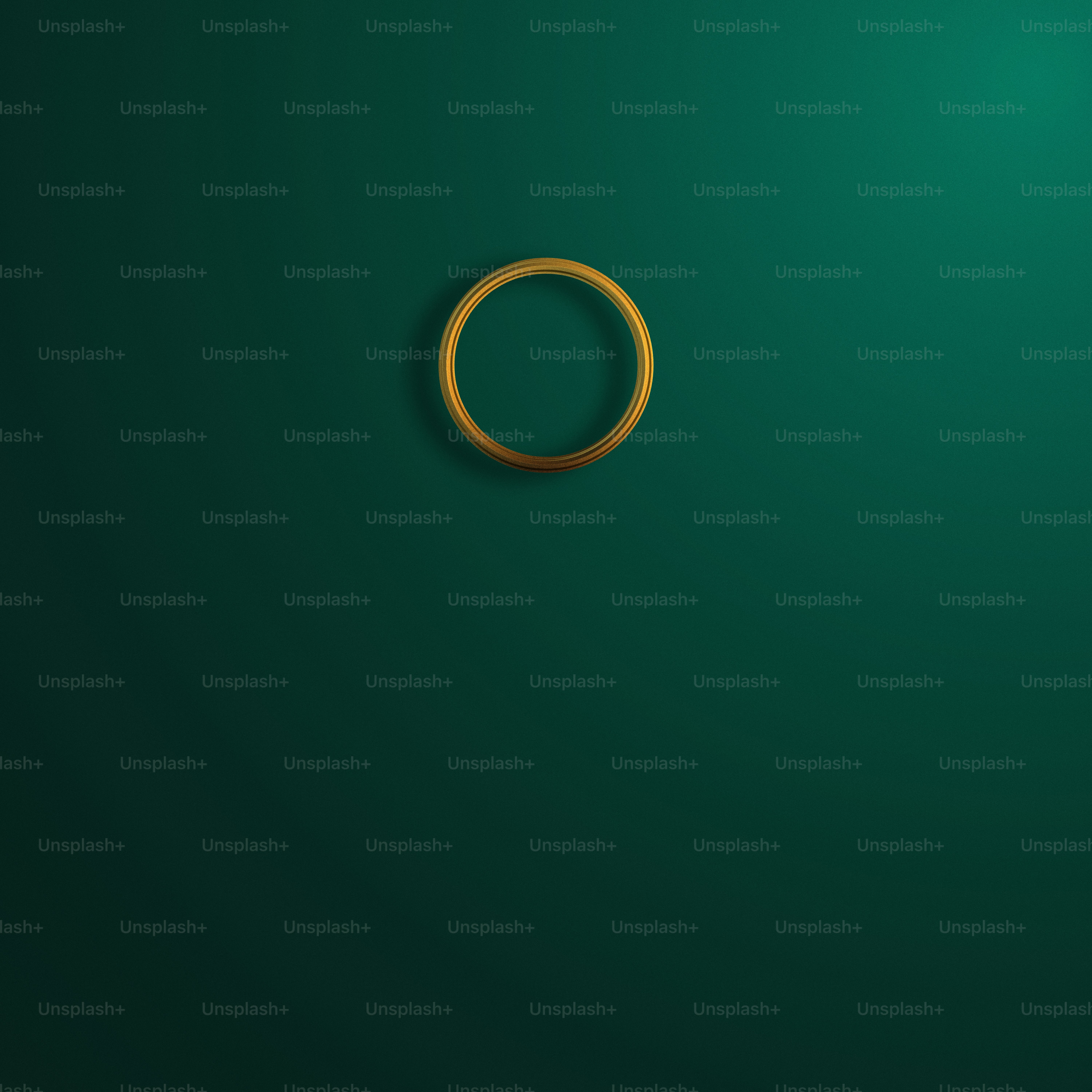 a gold ring on a green background