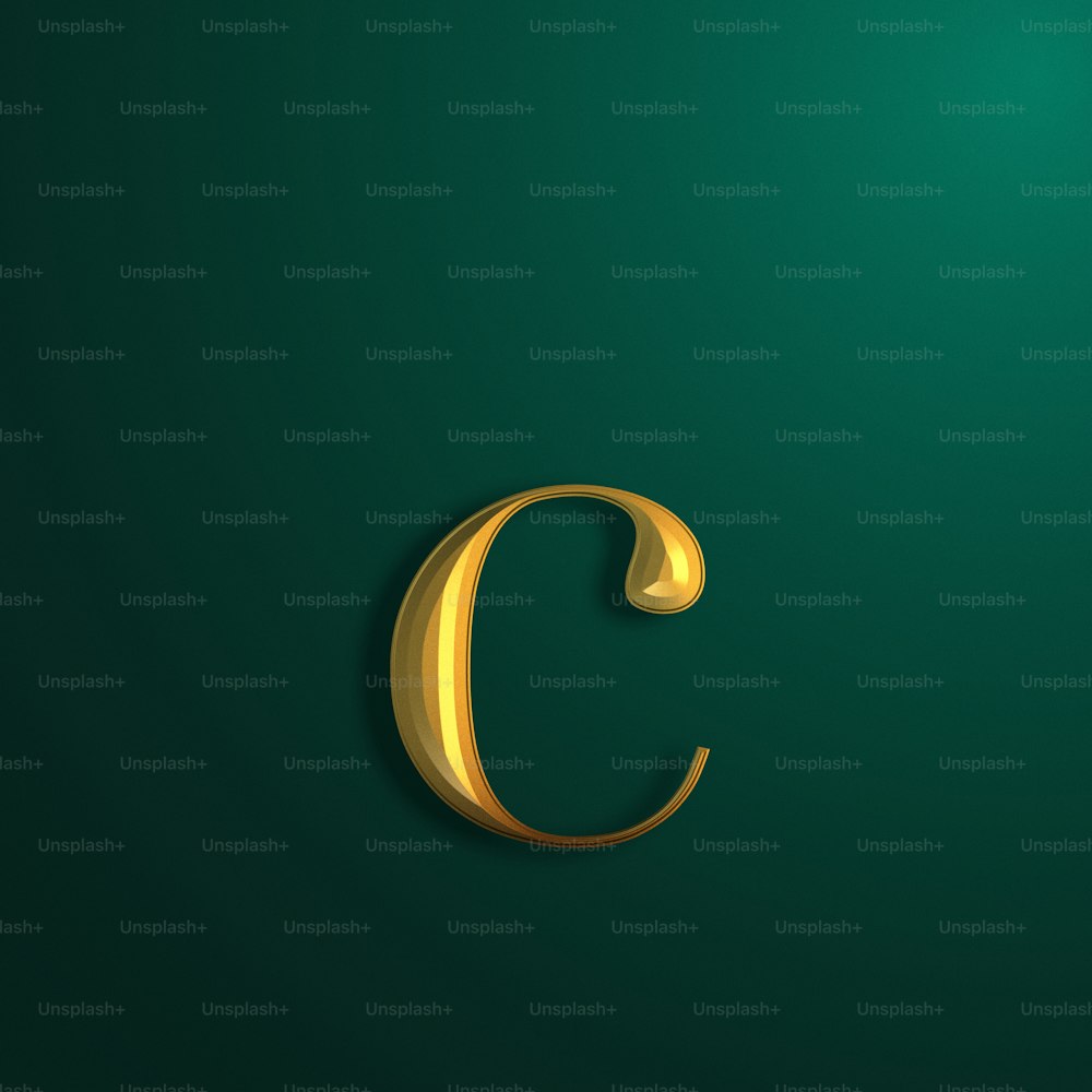 a gold letter c on a green background