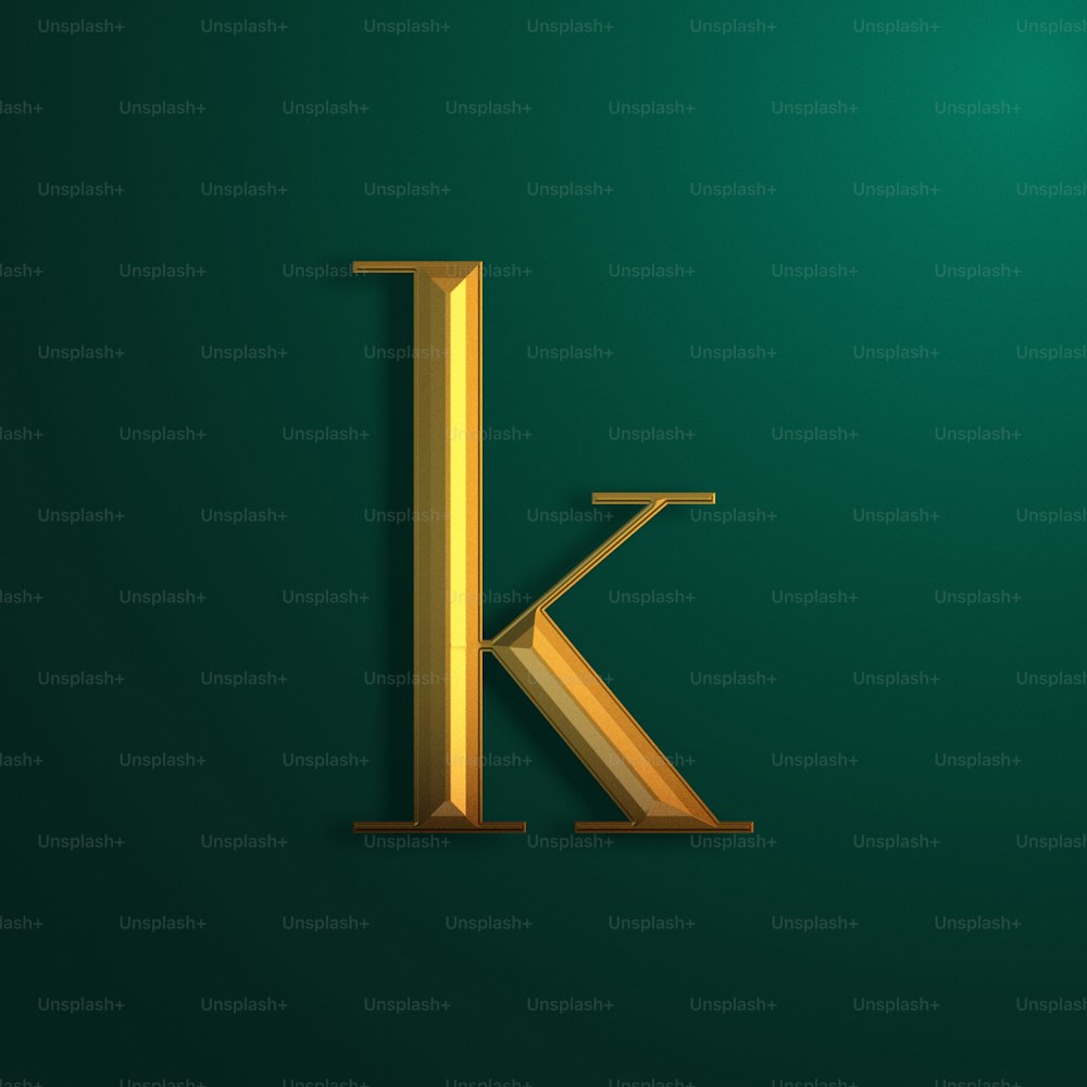 a gold letter k on a green background