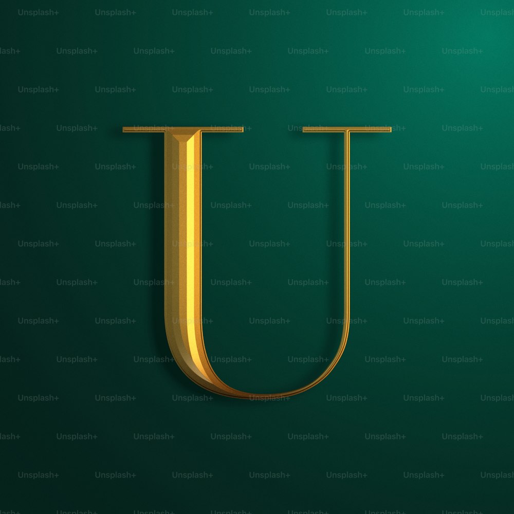 a gold letter u on a green background