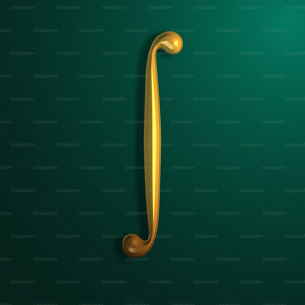 a gold letter j on a green background