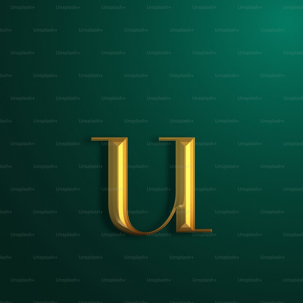 a gold letter u on a green background