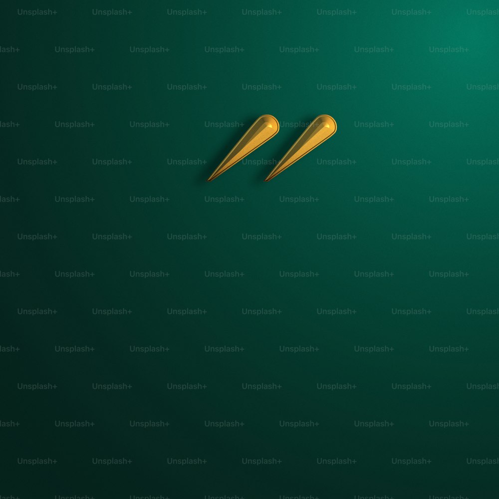 a pair of gold scissors on a green background