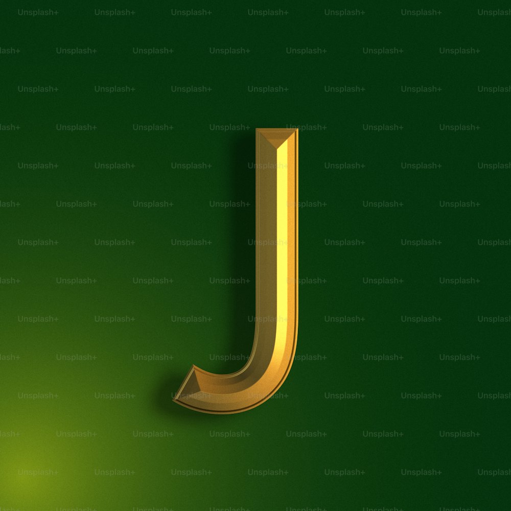 a gold letter j on a green background