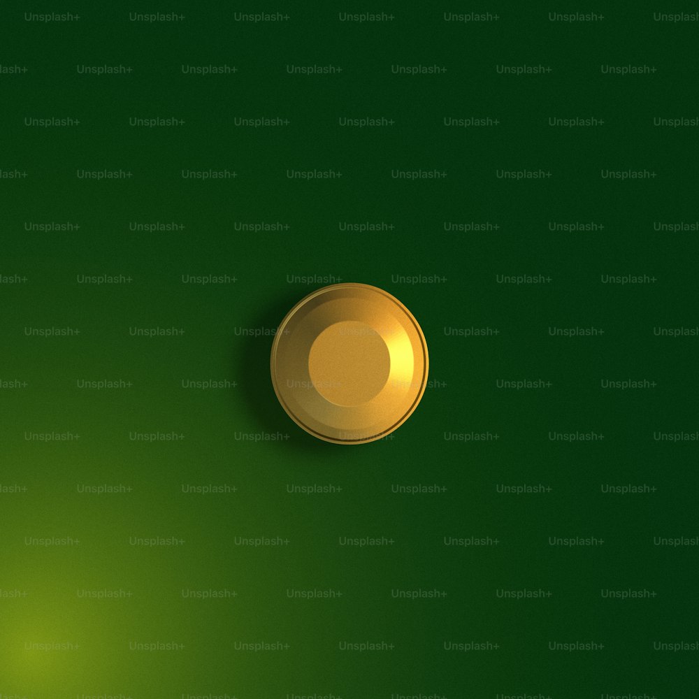 a shiny gold button on a green background