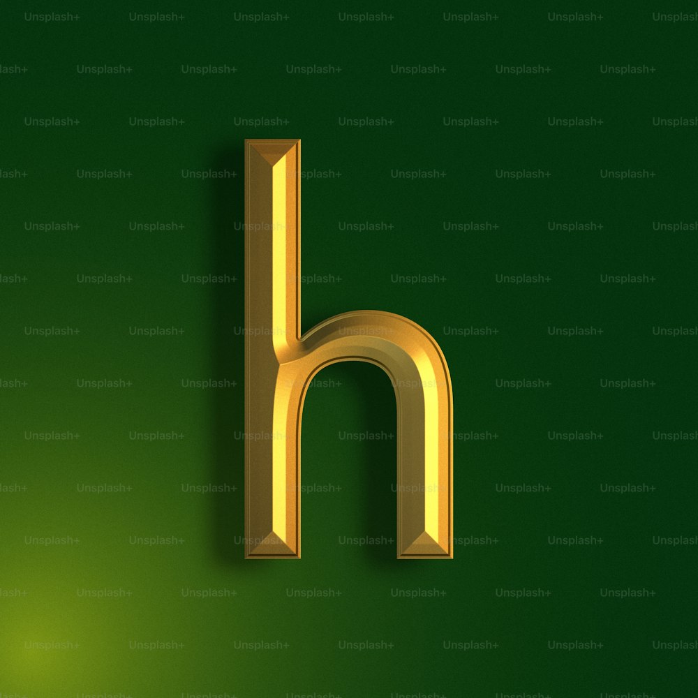 a gold letter h on a green background