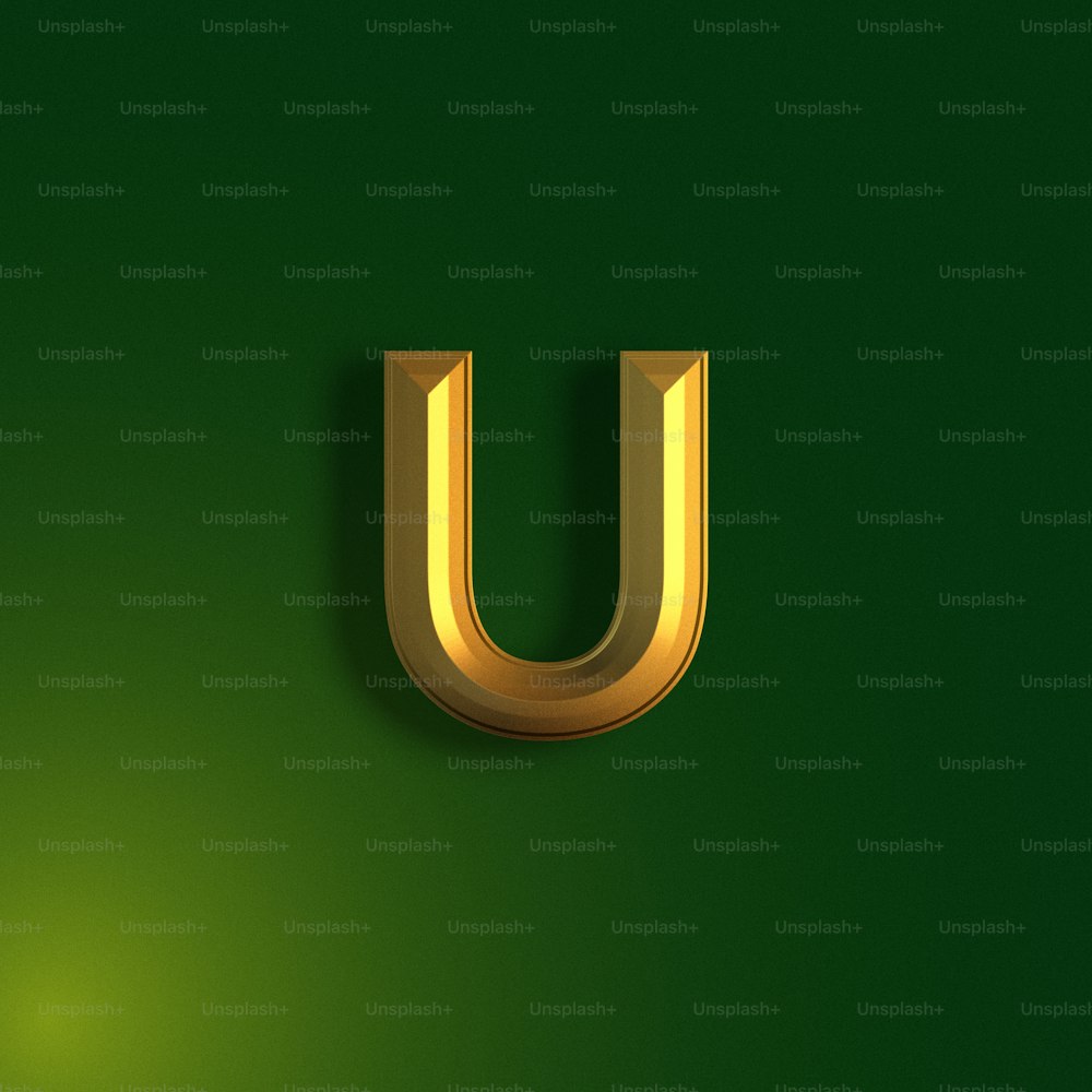 a gold letter u on a green background