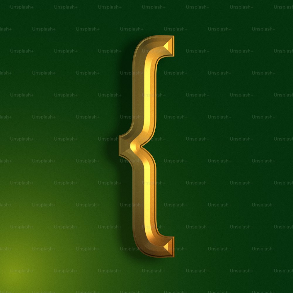 a gold letter that is on a green background