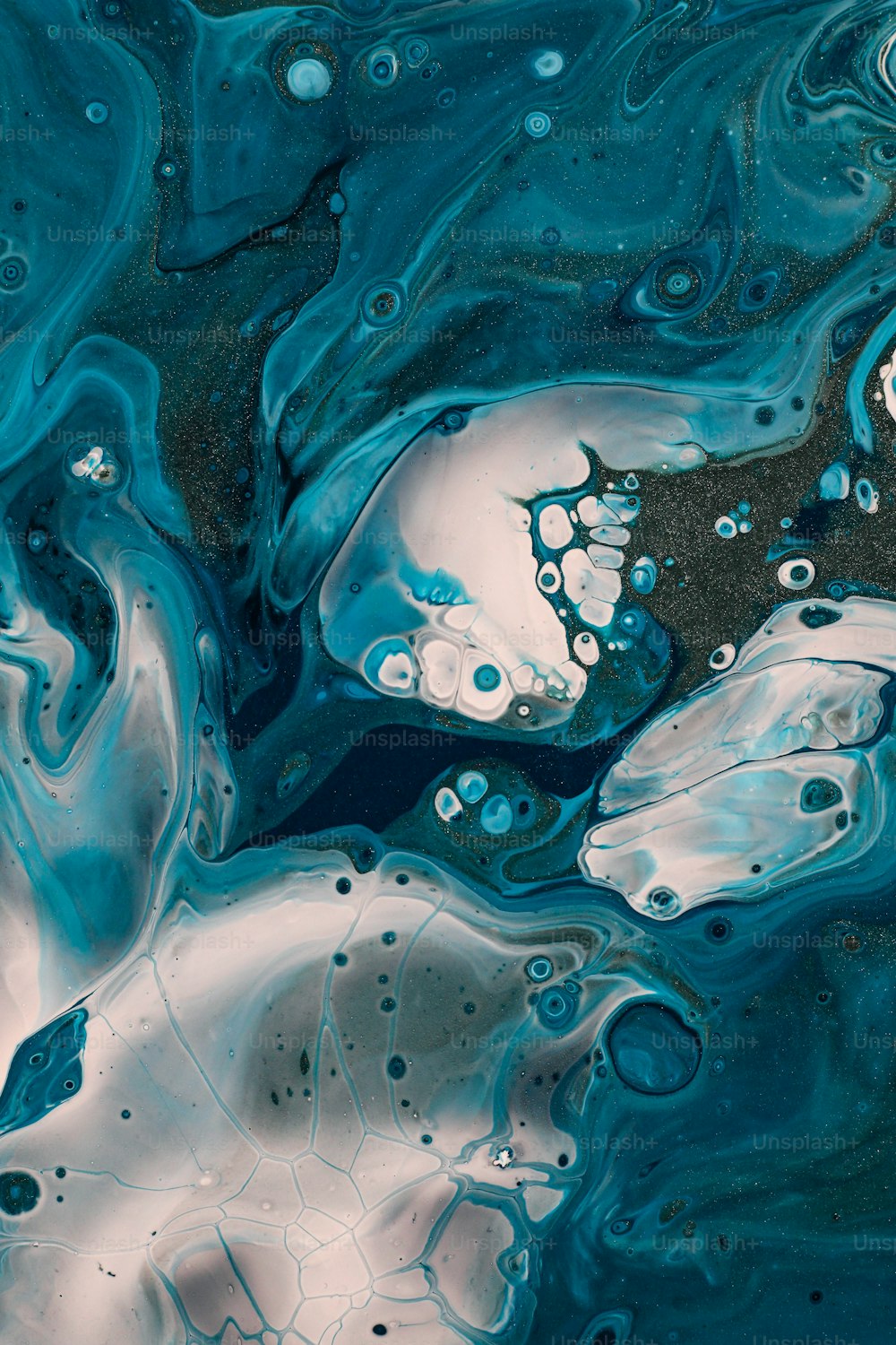 a close up of a blue and white liquid