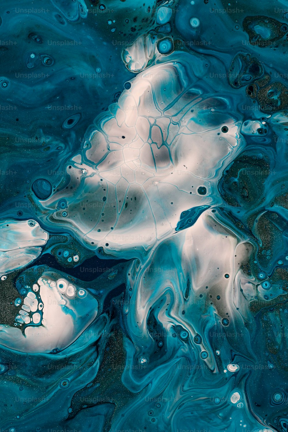 a close up of a blue and white liquid