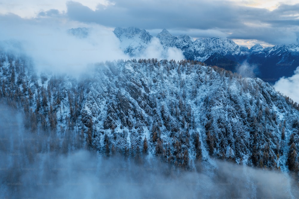 an aerial view of a mountain covered in snow