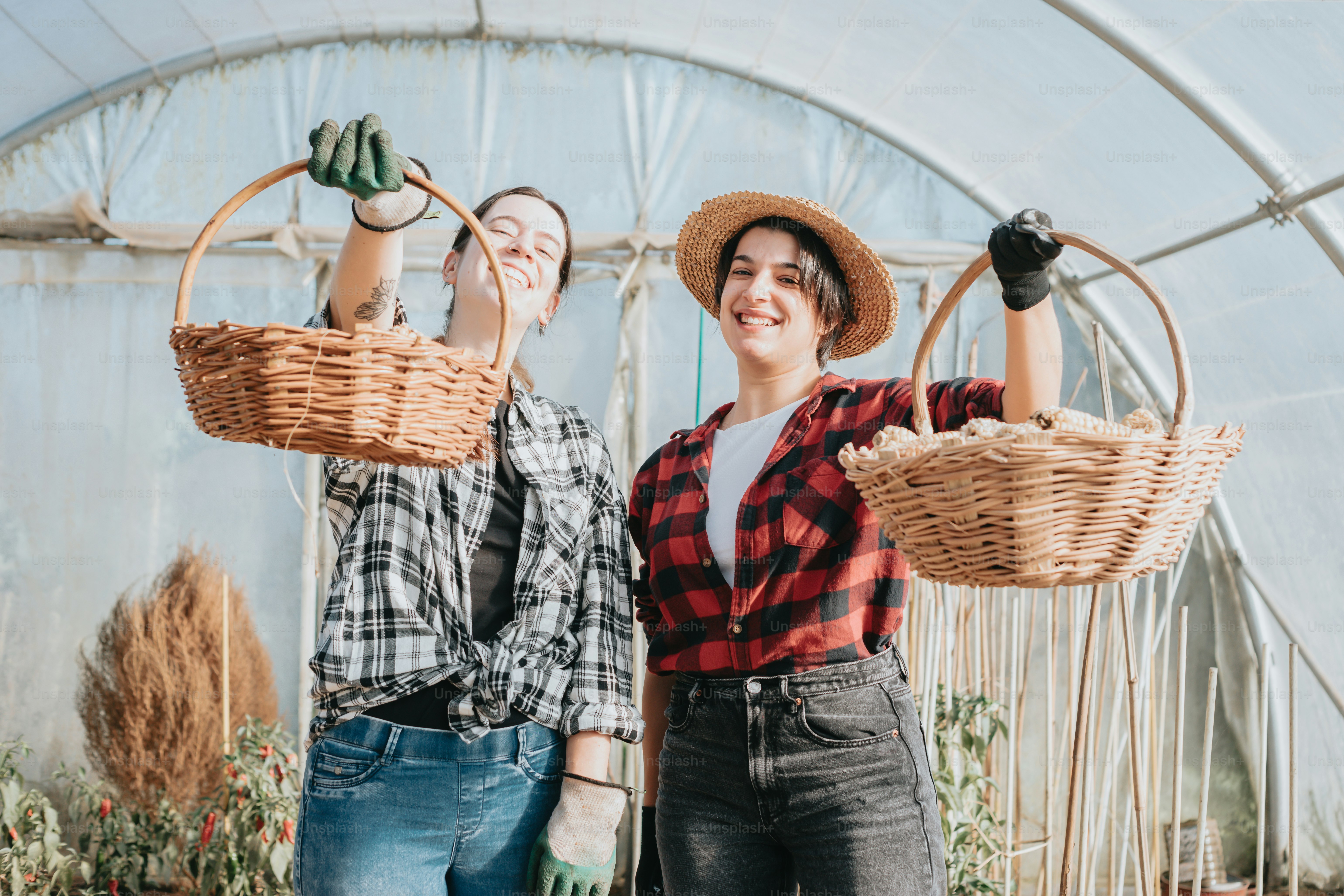 a couple of women standing next to each other holding baskets