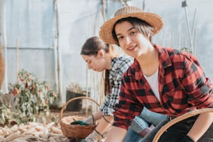 two women are working in a garden center