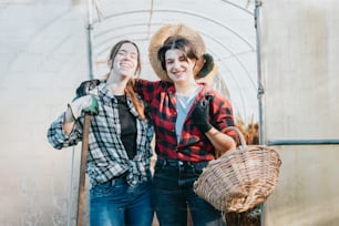 two women standing next to each other holding baskets