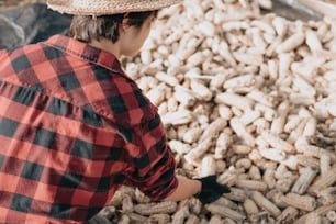 a man standing in front of a pile of peanuts