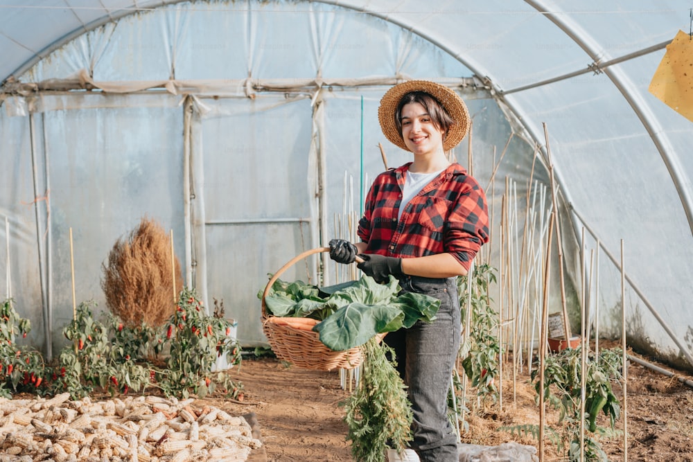 a woman holding a basket of vegetables in a greenhouse