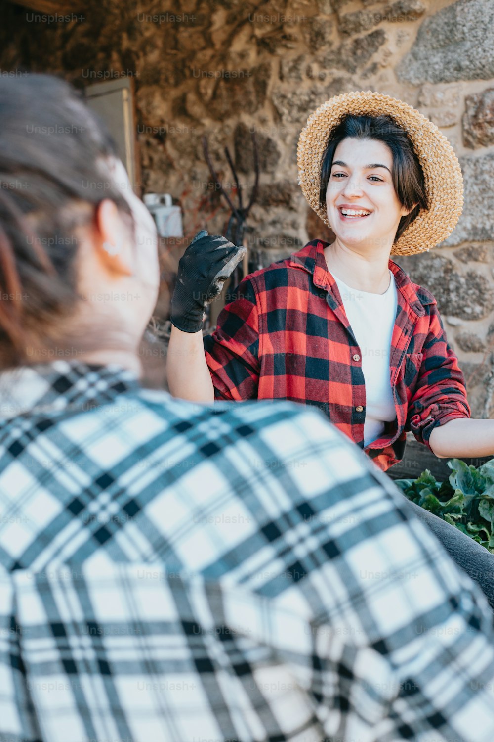 a woman in a plaid shirt is talking to another woman