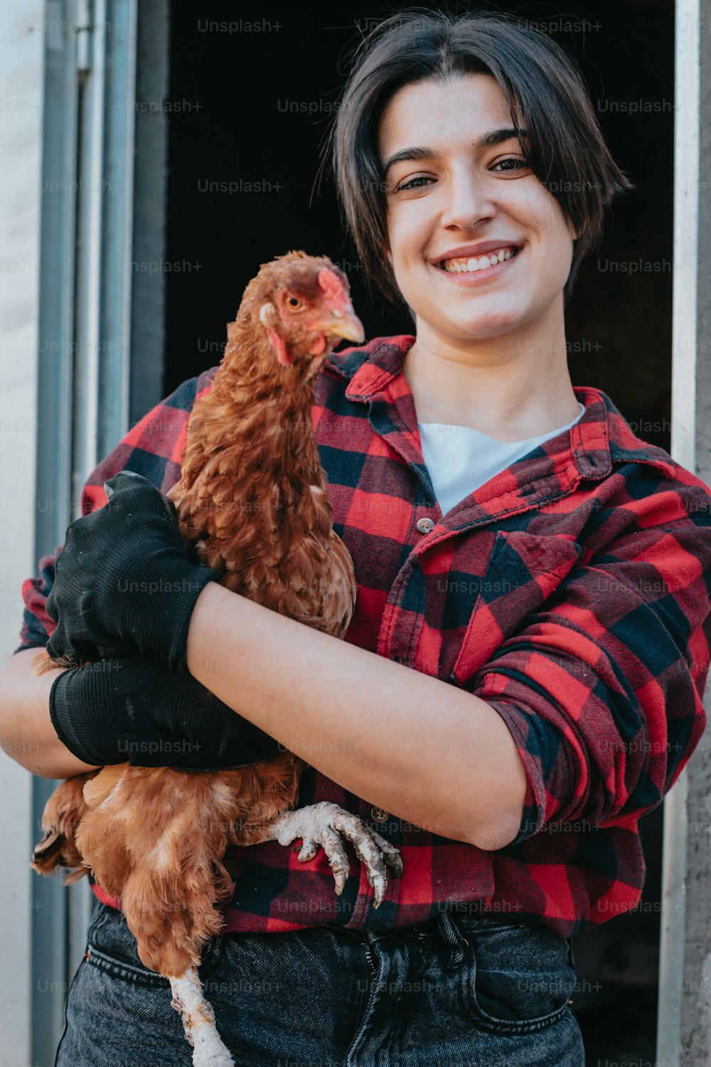 a woman holding a chicken in her arms