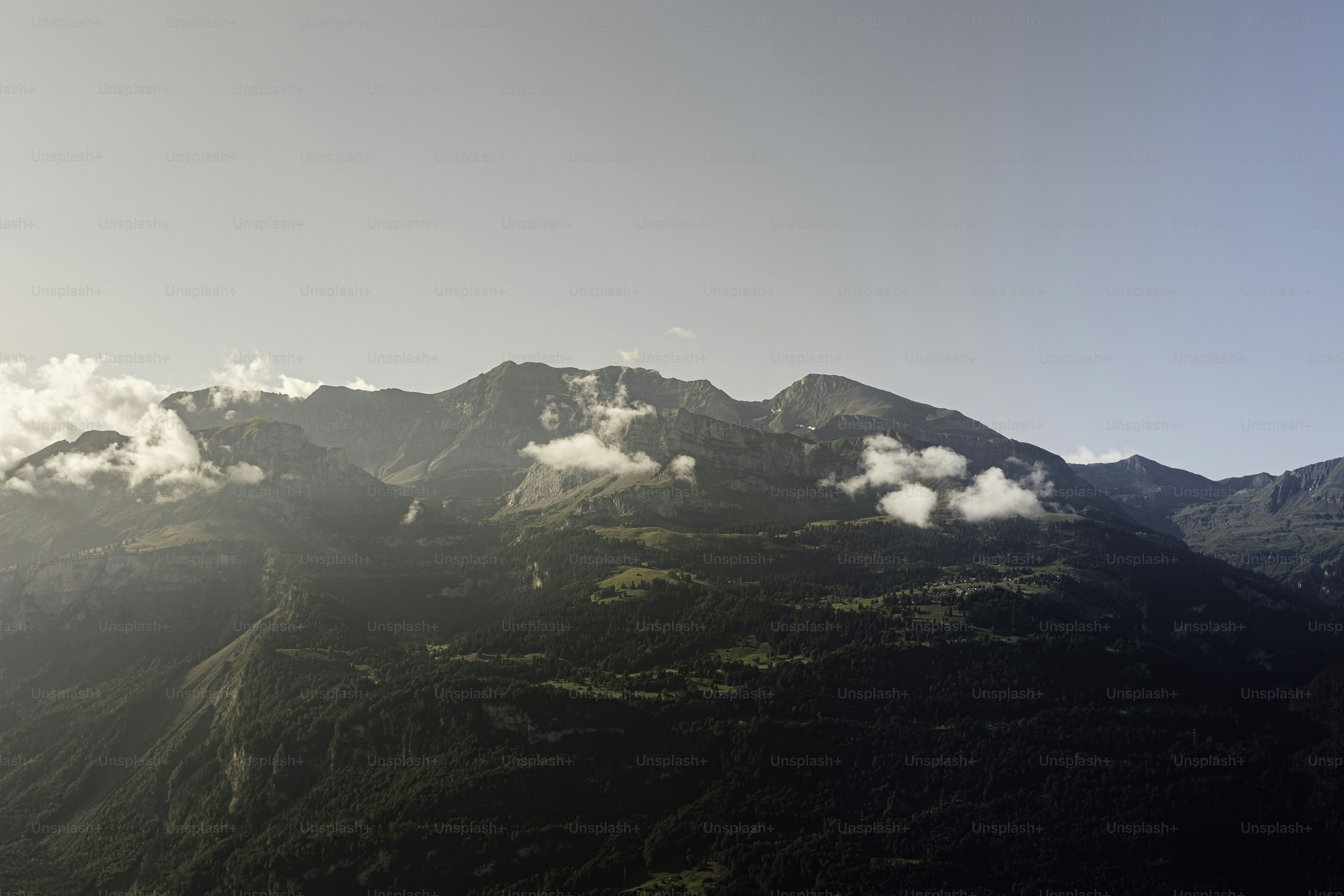 a view of a mountain range with clouds in the sky