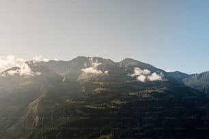 a view of a mountain range with clouds in the sky