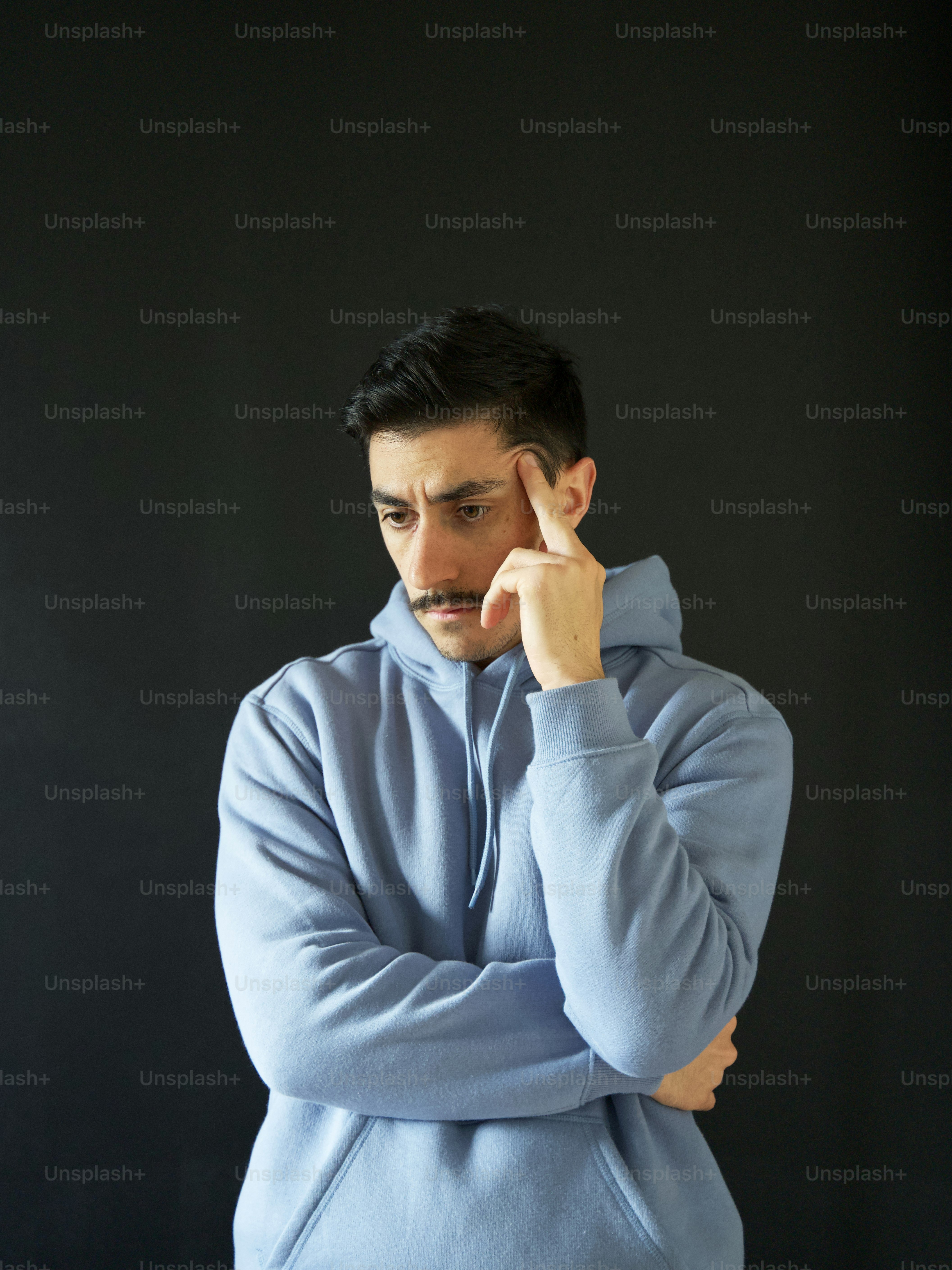 a man with his hand on his face