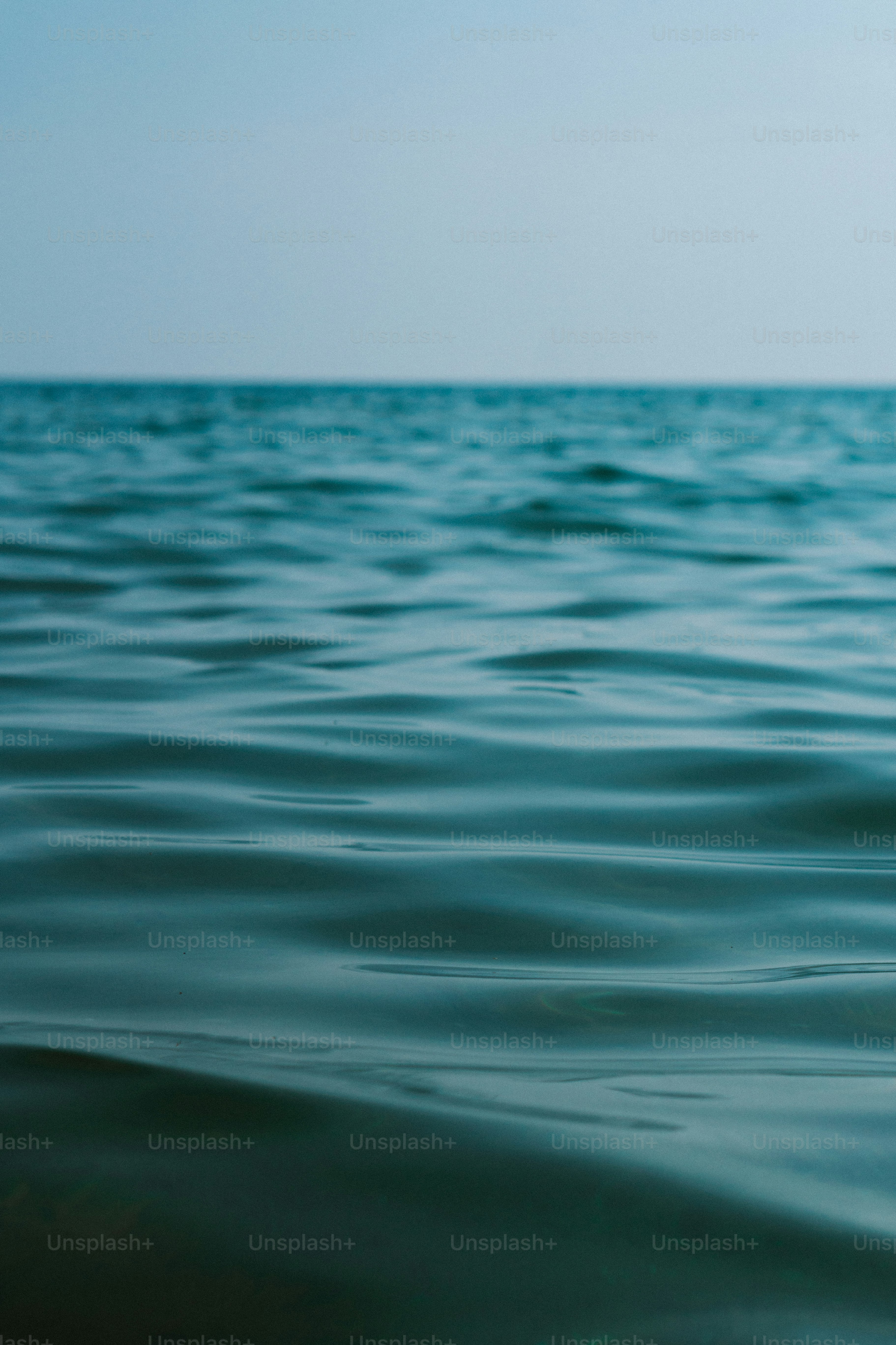 a body of water with a sky in the background