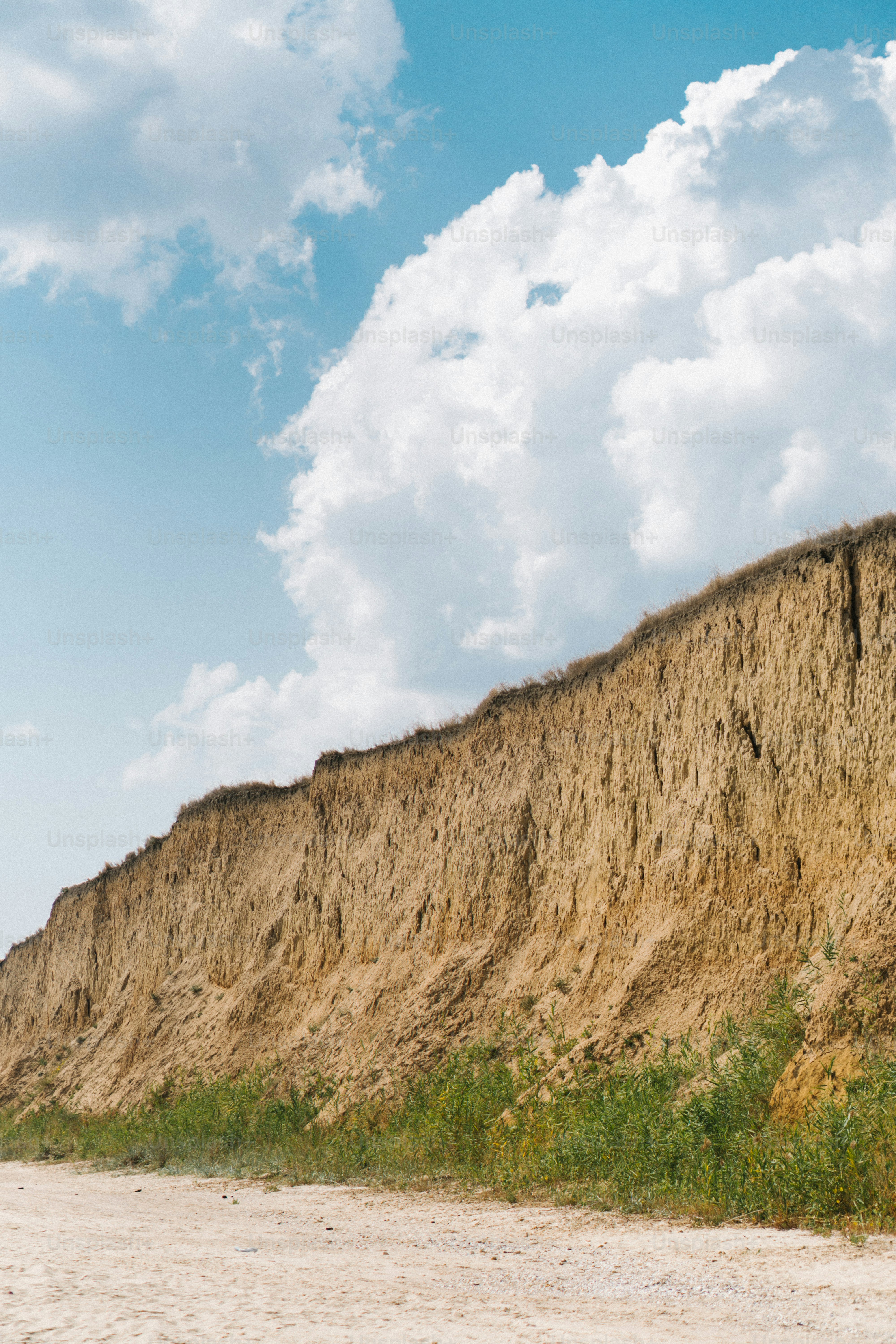 a man riding a surfboard on top of a sandy beach