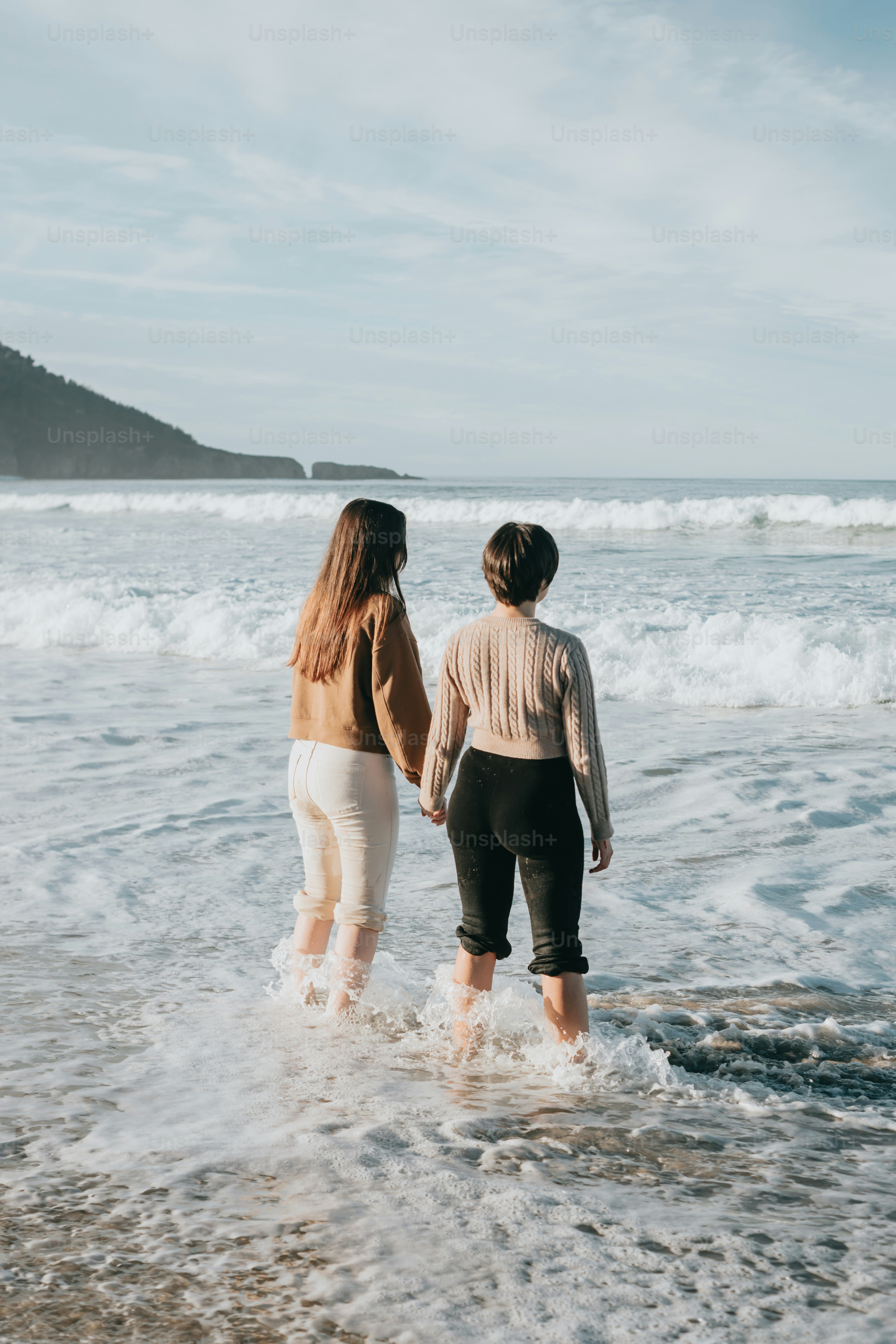 a couple of people that are standing in the water
