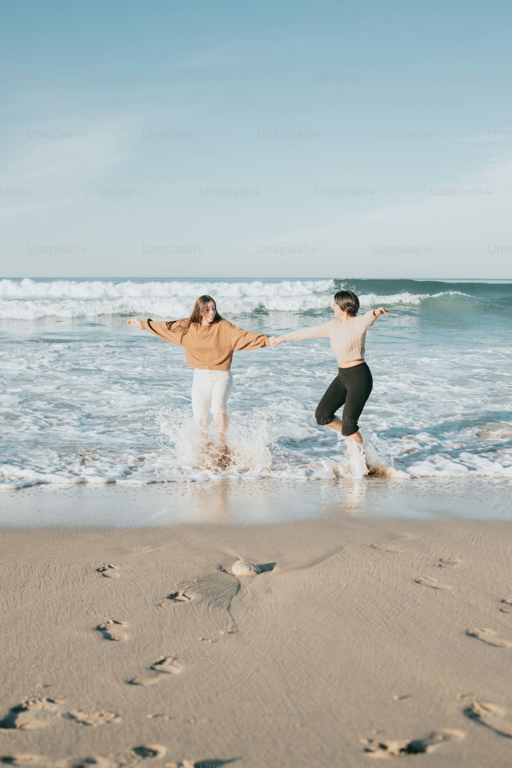 a couple of people that are standing in the water