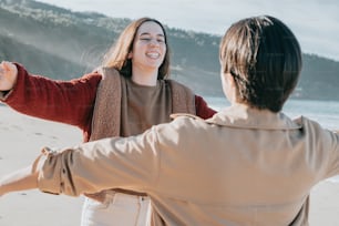 a couple of people that are standing in the sand