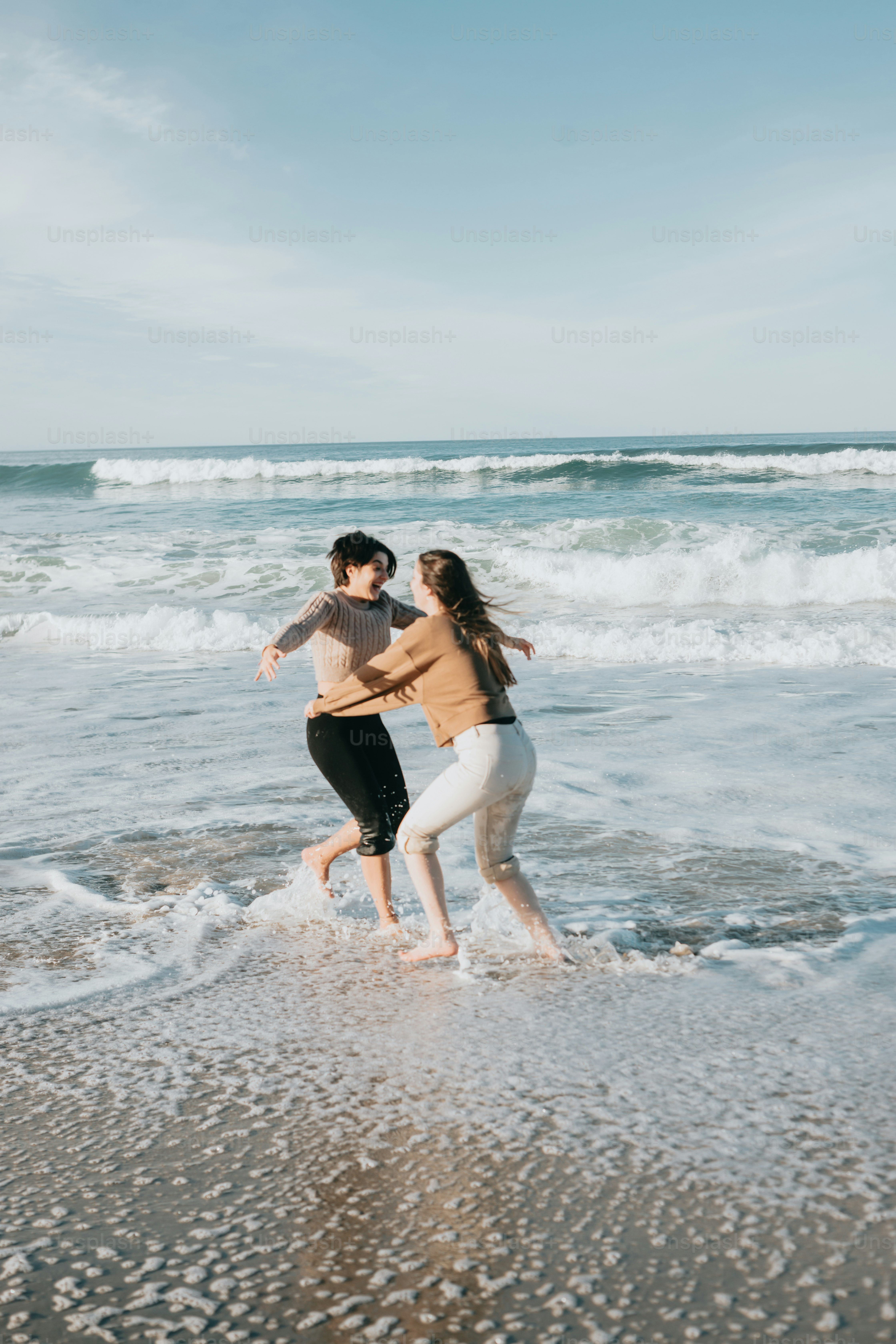 a couple of people that are standing in the water