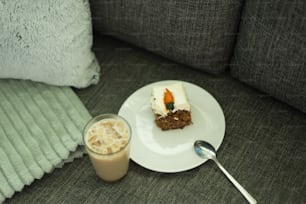 a white plate topped with a piece of cake next to a cup of coffee