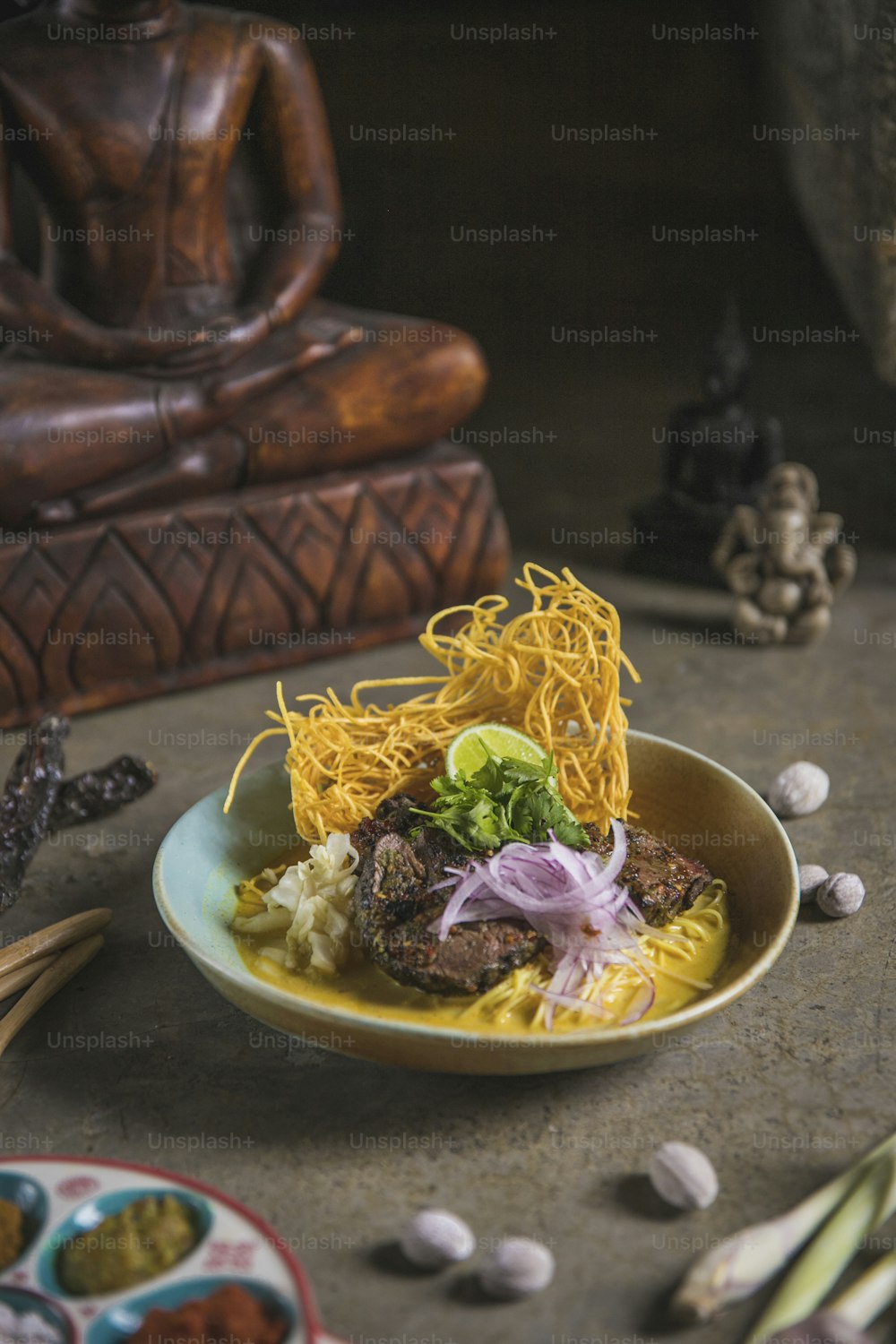 a plate of food with noodles and meat