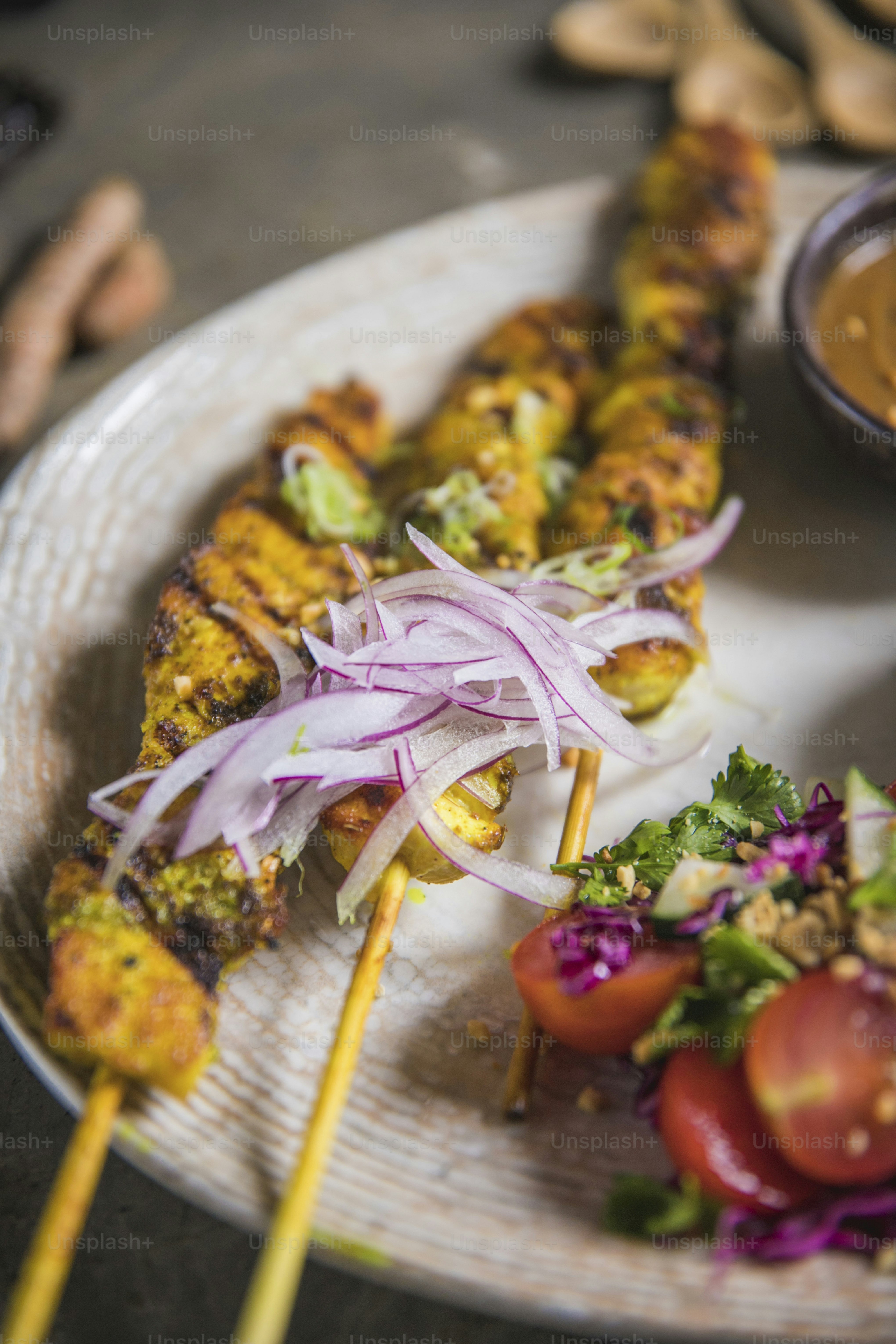 a white plate topped with a skewer of food