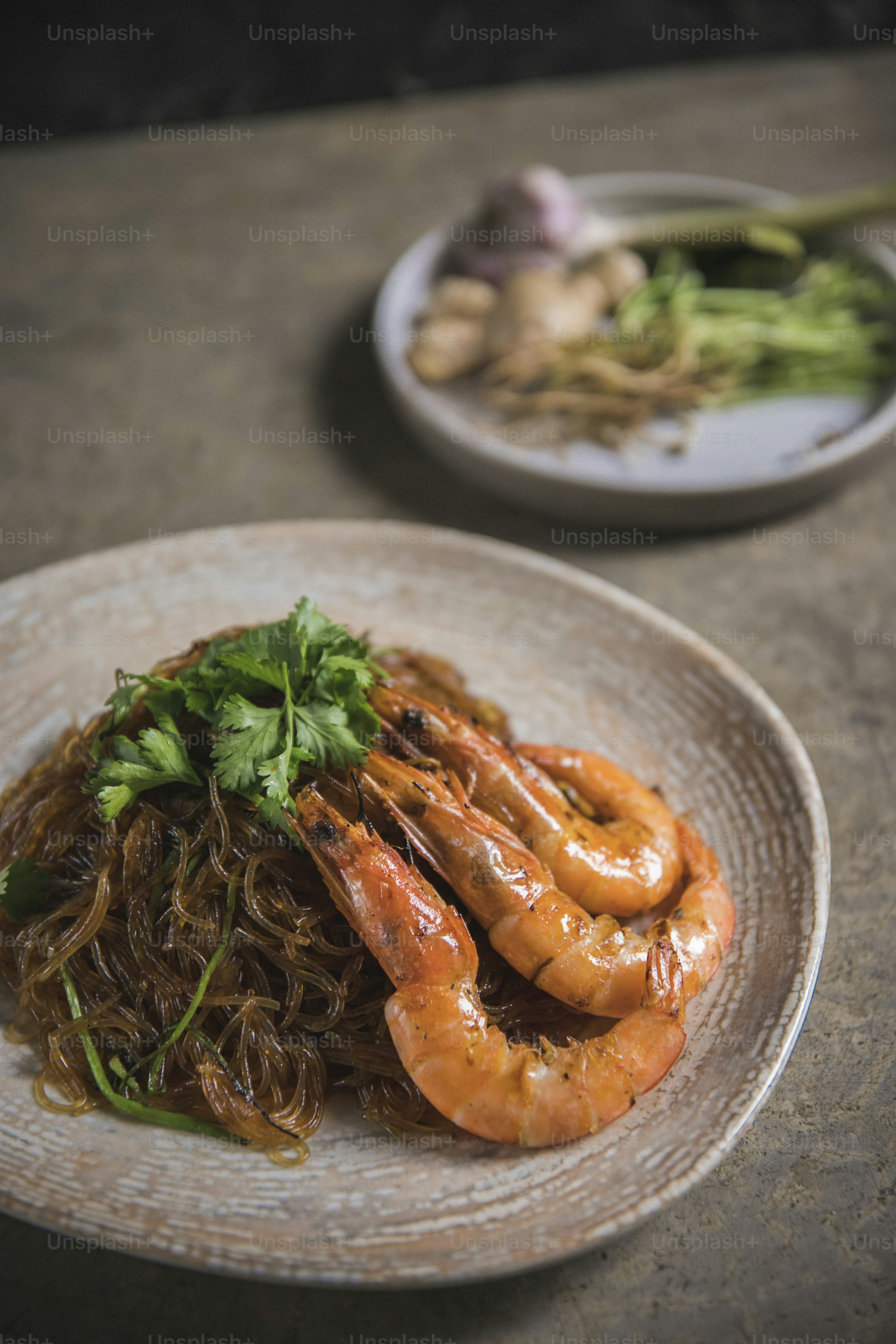 a plate of food with shrimp and noodles