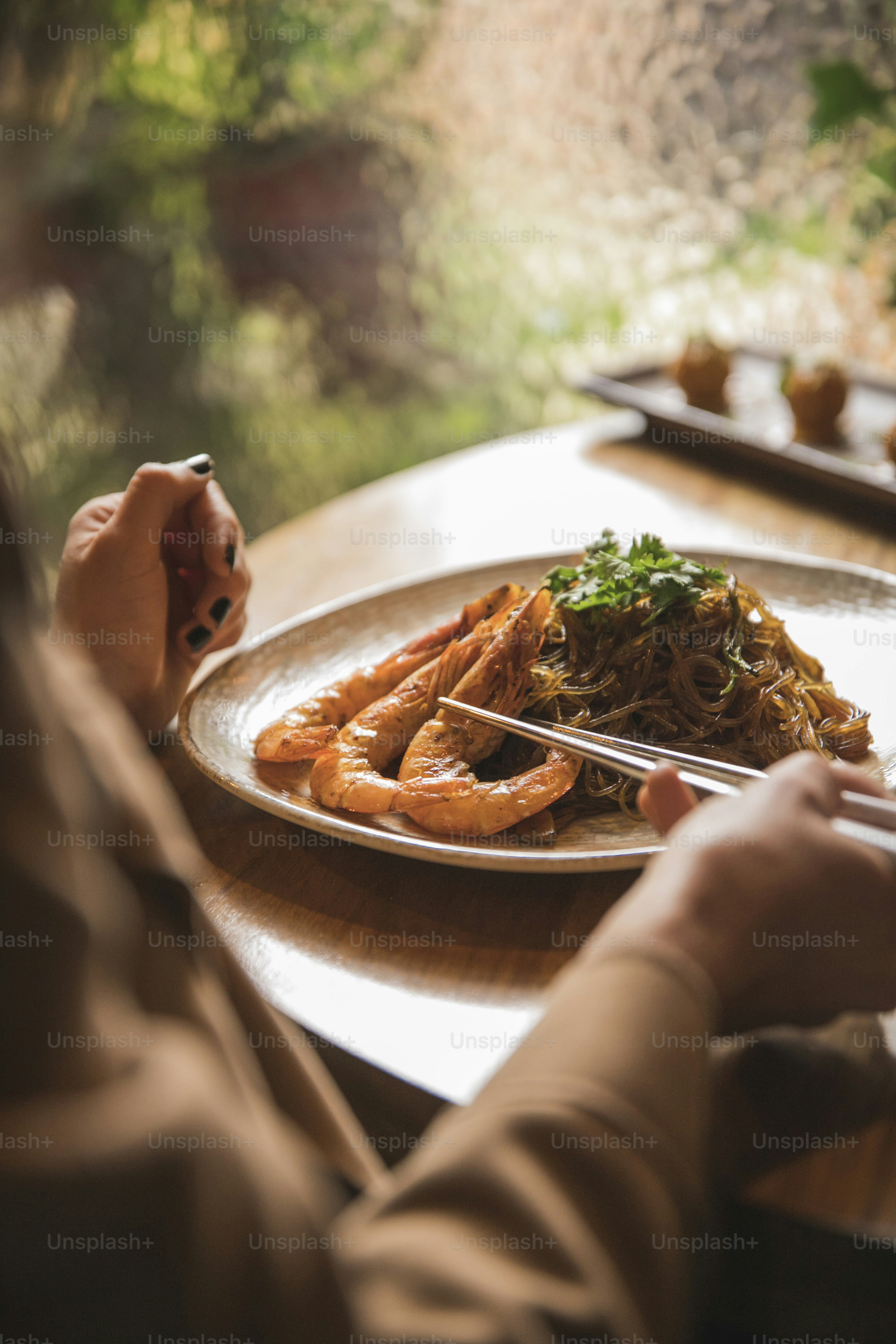 a person sitting at a table with a plate of food