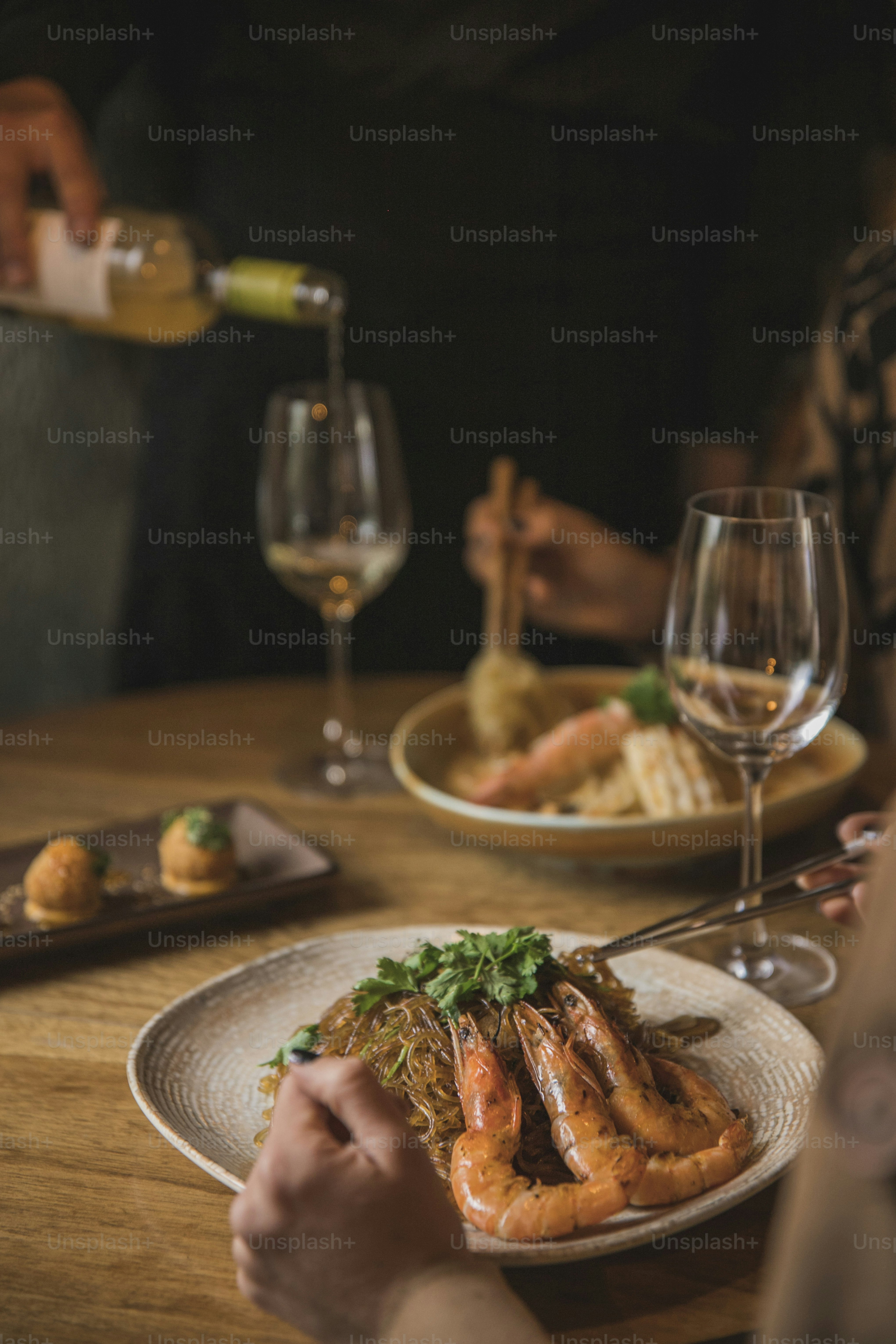 a person sitting at a table with a plate of food