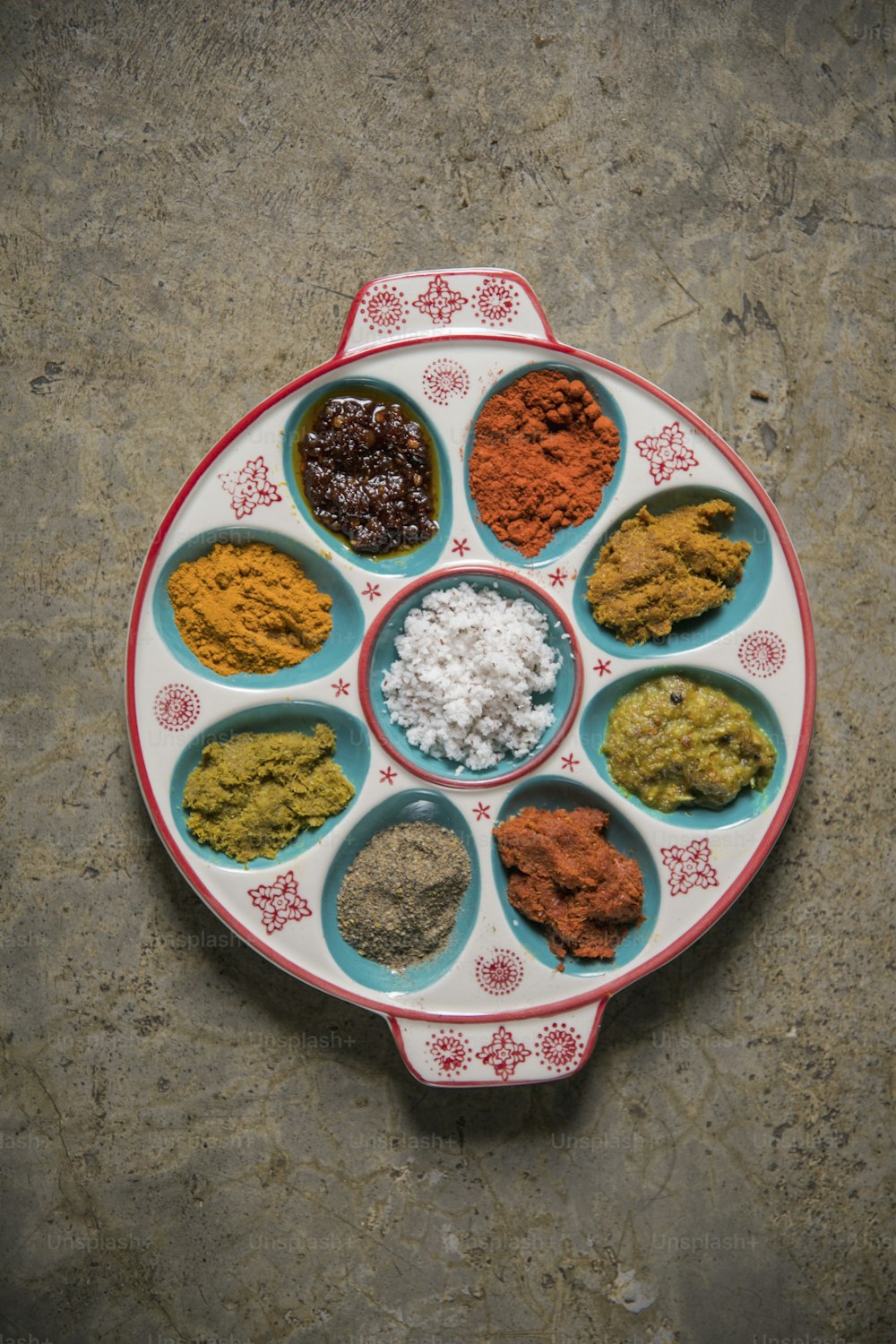 a plate of different spices on a table