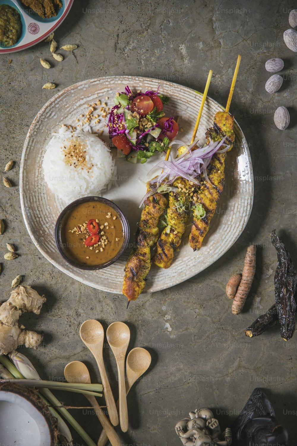 a plate of food on a table with spoons