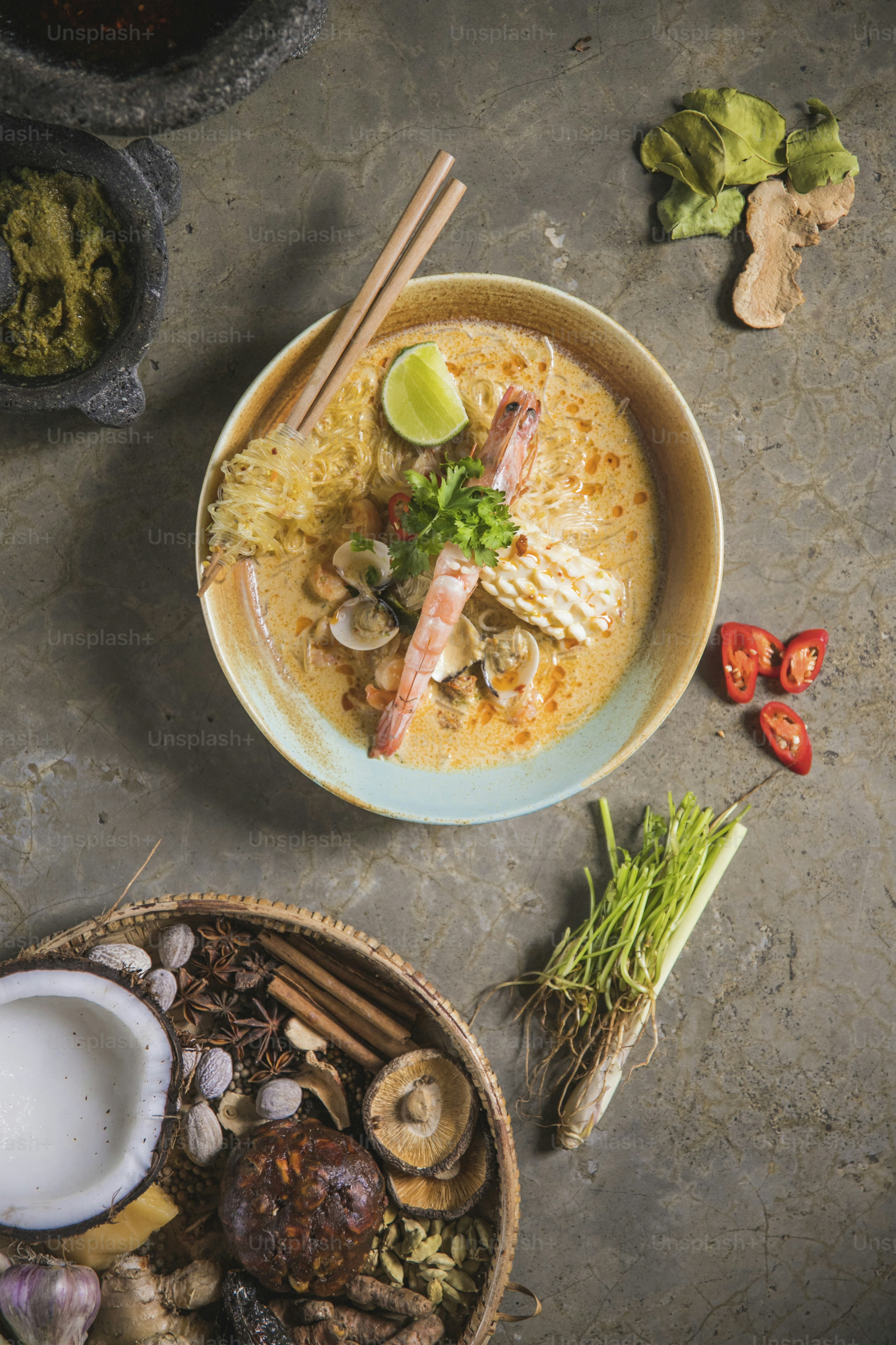 a bowl of food on a table with chopsticks