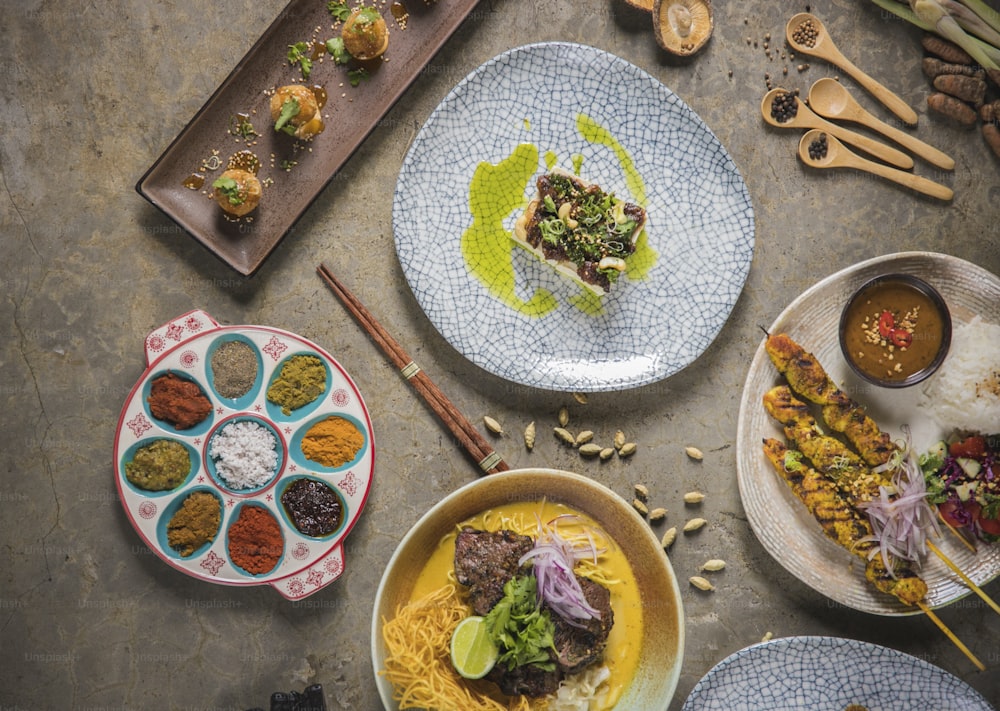 a table topped with plates filled with food