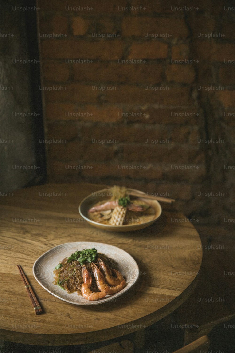 two plates of food on a wooden table