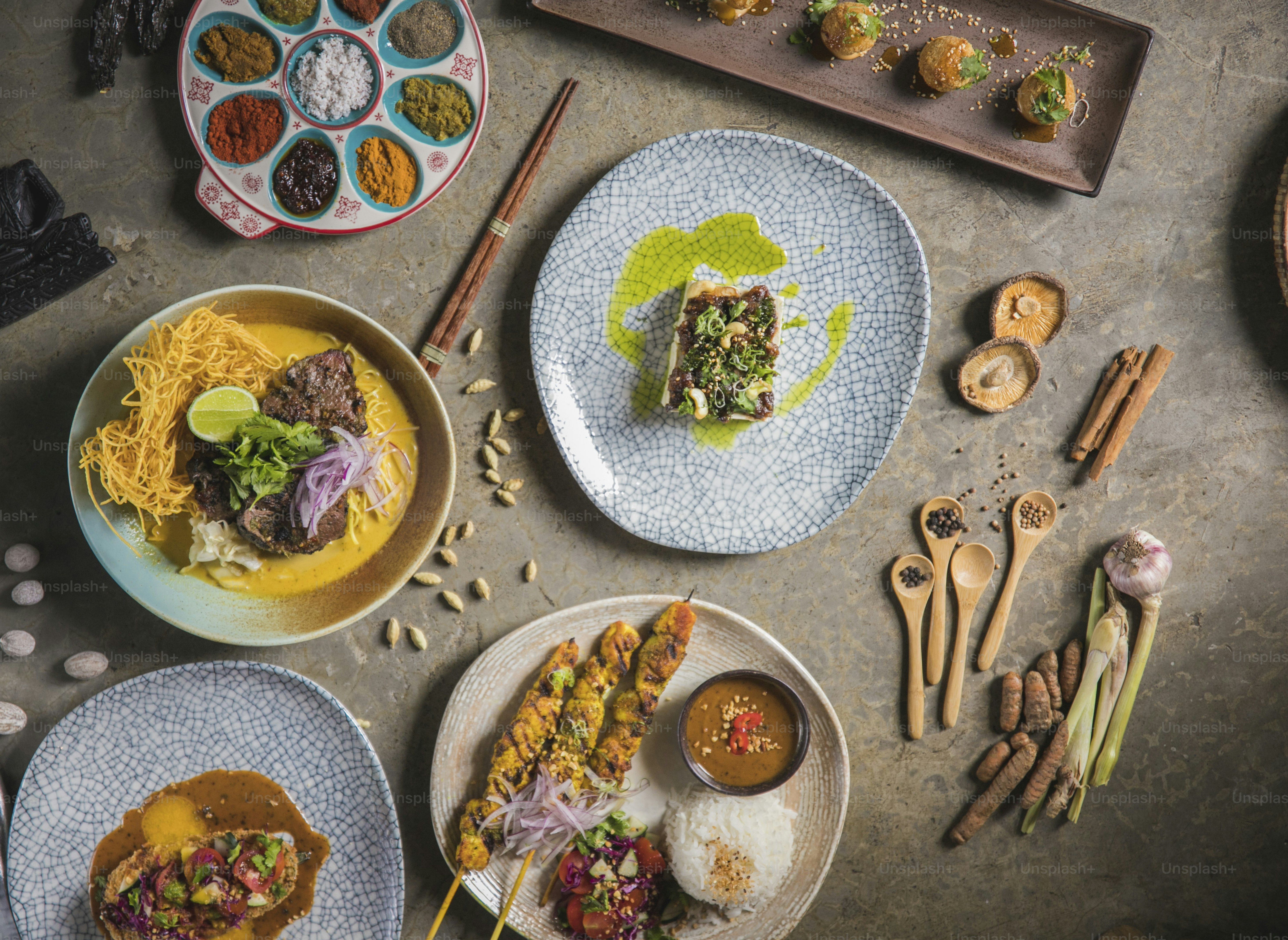 a table topped with plates of food and utensils